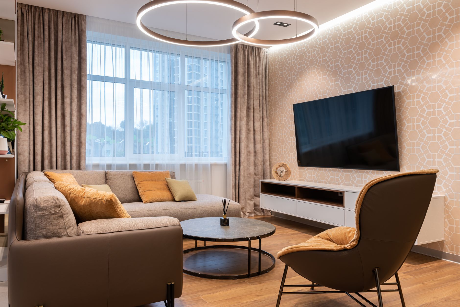 Small apartment living room with round coffee table and pendant light