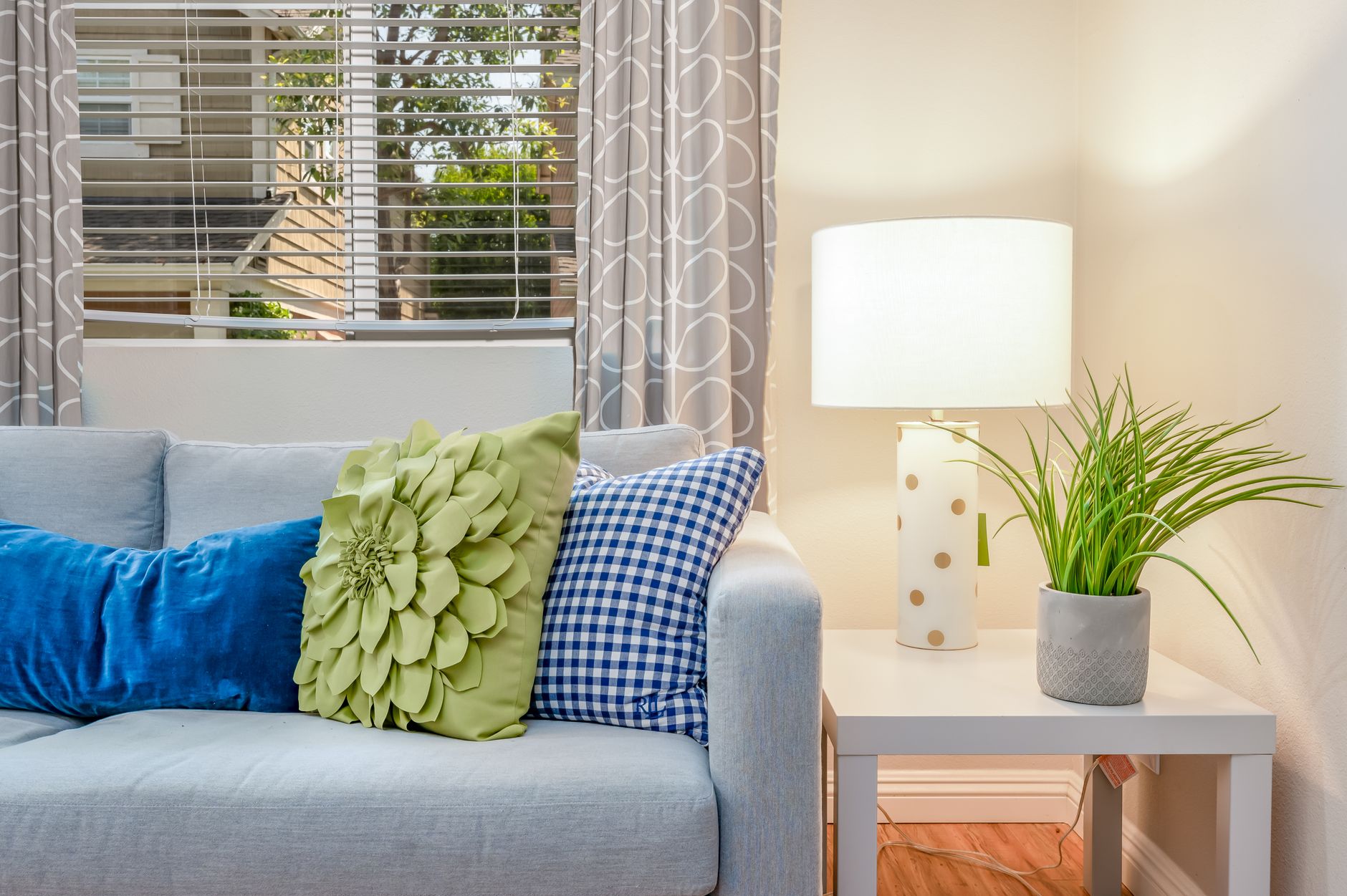 Throw pillows on a couch creating a cozy styled apartment living room
