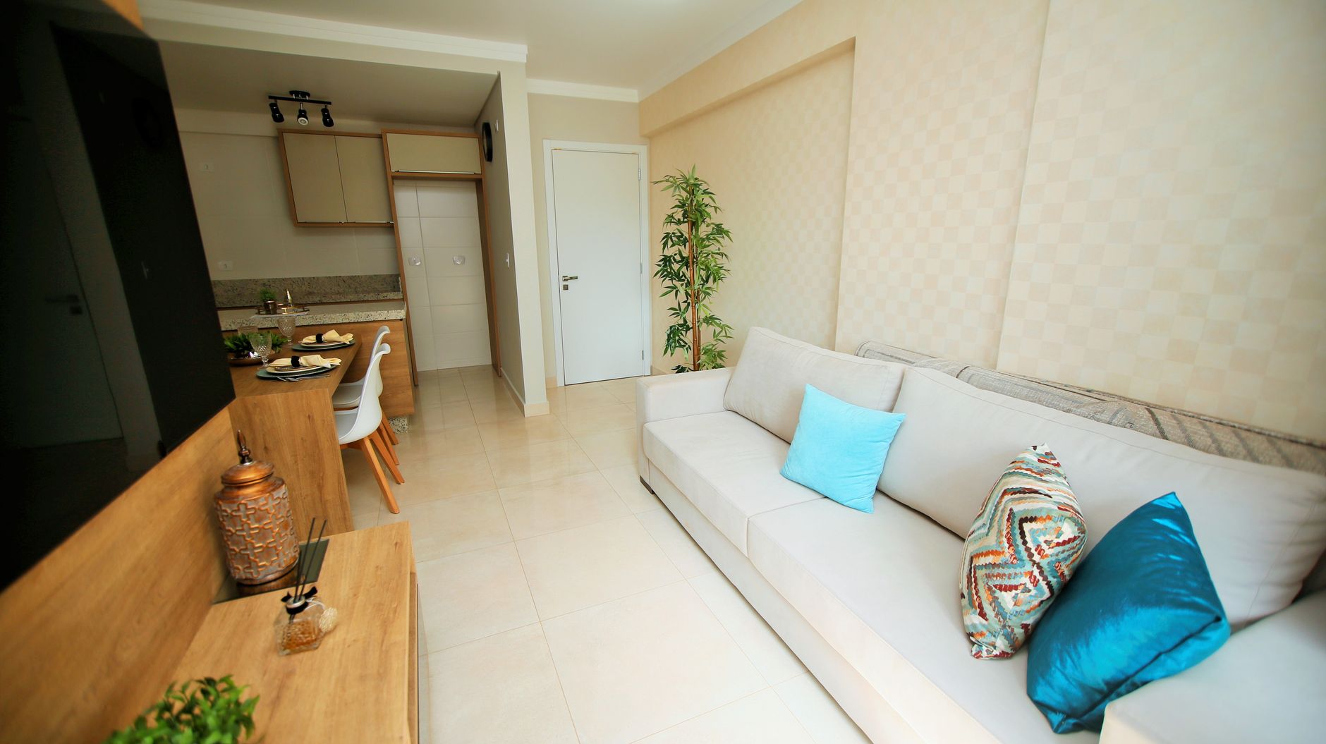 Small apartment living room with white sofa and compact furniture layout