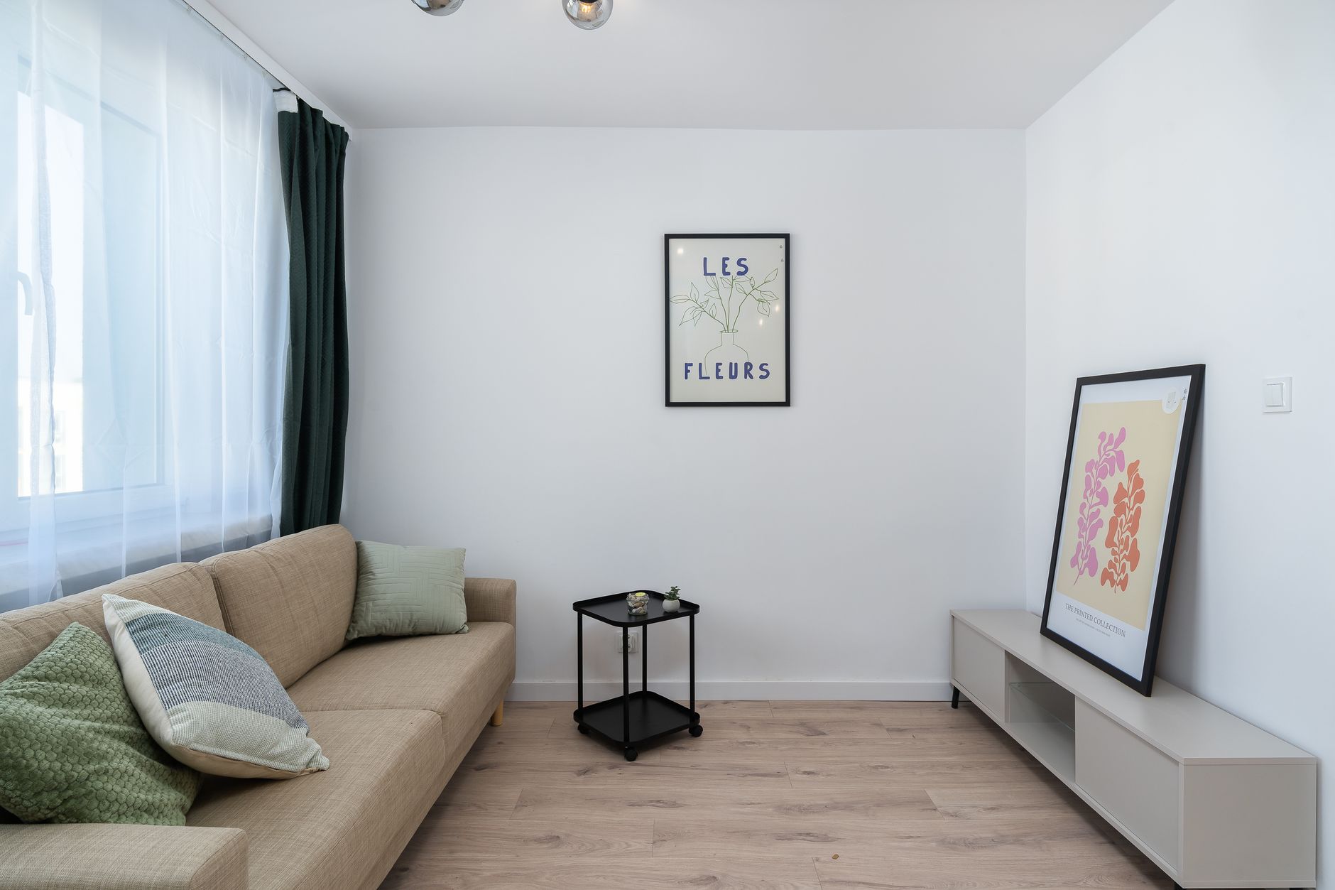 Minimalist apartment living room with neutral linen sofa and white walls