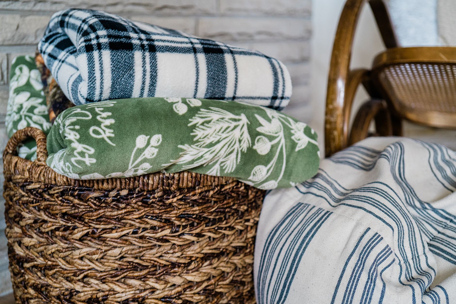 Soft blankets stored in a wicker basket for apartment living room storage