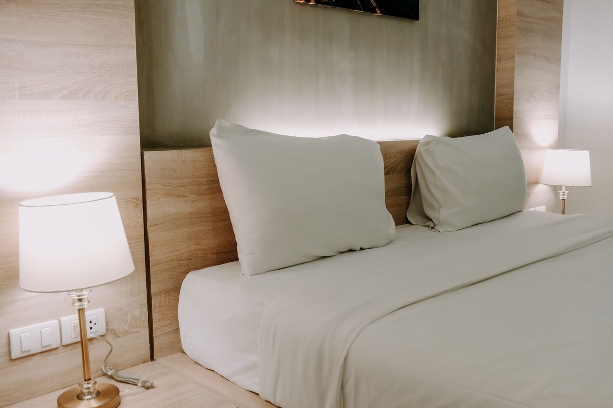 Cozy and organized college dorm room setup with neutral bedding and warm decor