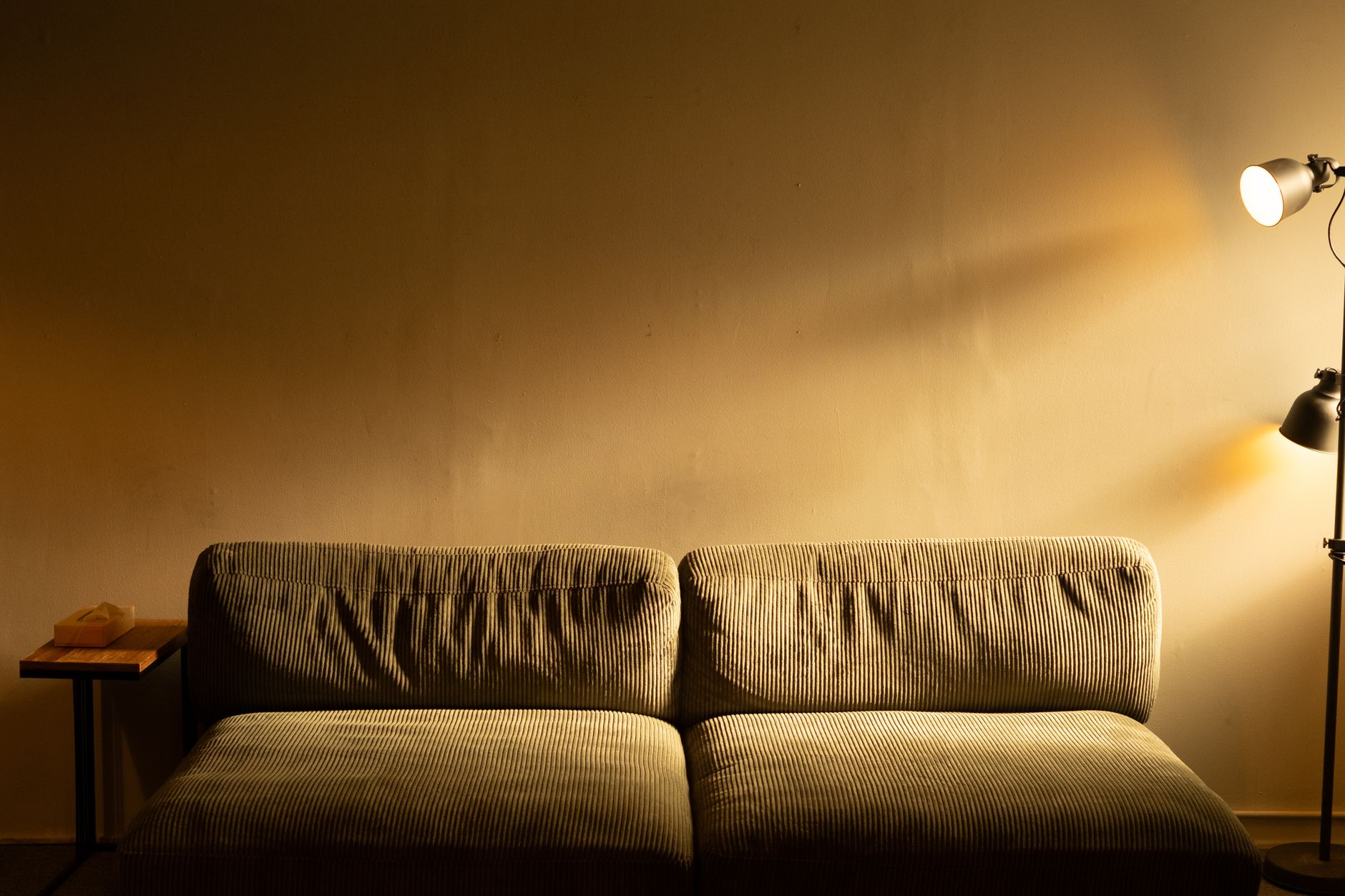 Warm floor lamp casting soft glow in cozy living room zone