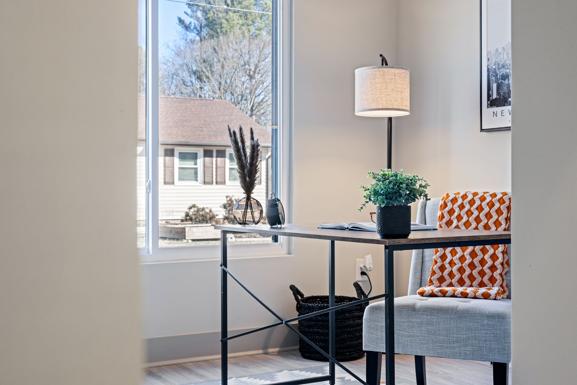 Minimalist home office desk with lamp by window in small apartment