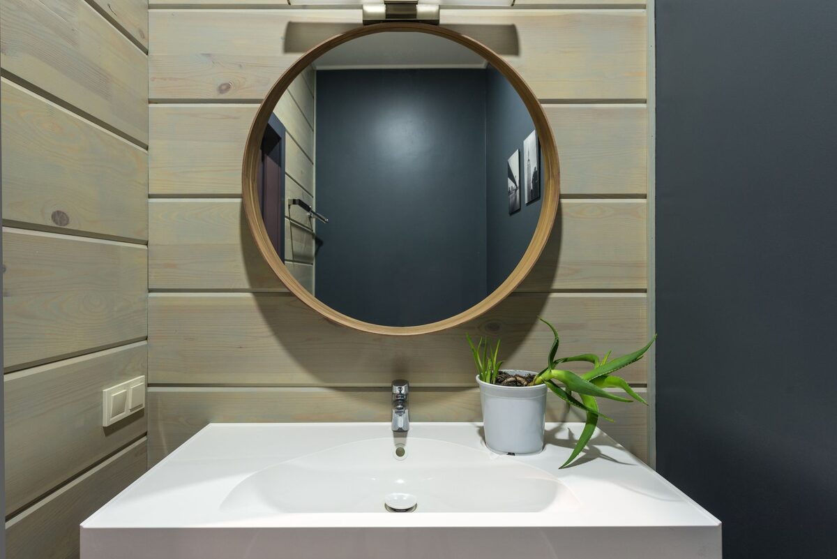 Mirror trick small rental bathroom to look bigger