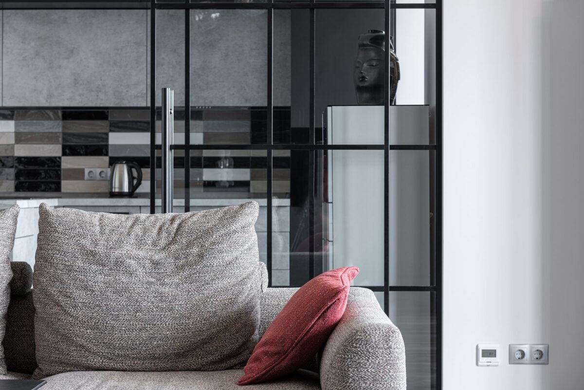 moody apartment aesthetic with dark textiles and brass accents