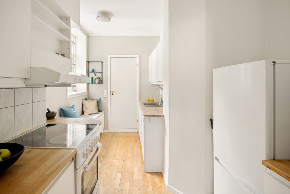Bright modern apartment kitchen interior with white cabinets
