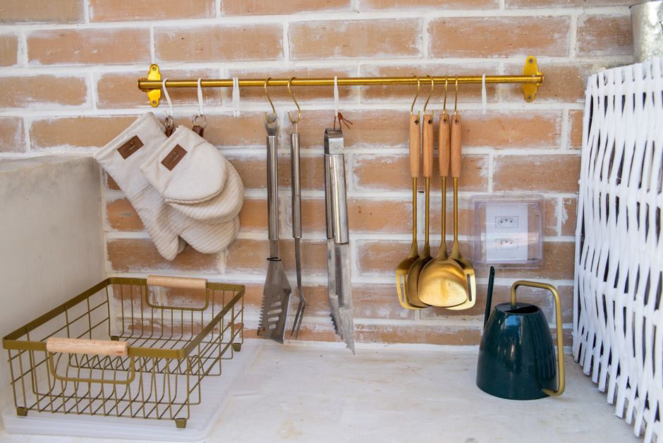 Kitchen pegboard wall organizer with utensils and pots