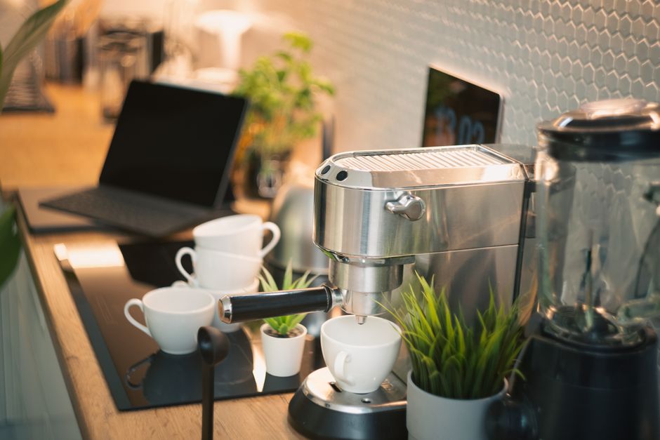 Beautifully styled kitchen counter with coffee maker and plants on a tray