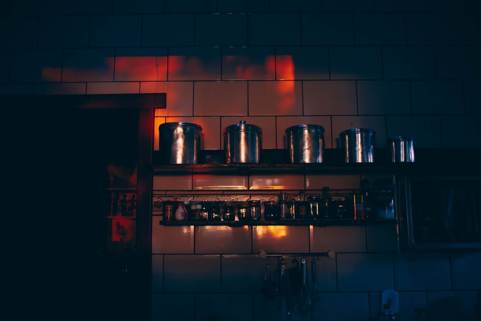 Warm layered kitchen lighting creating a cozy ambiance in the evening