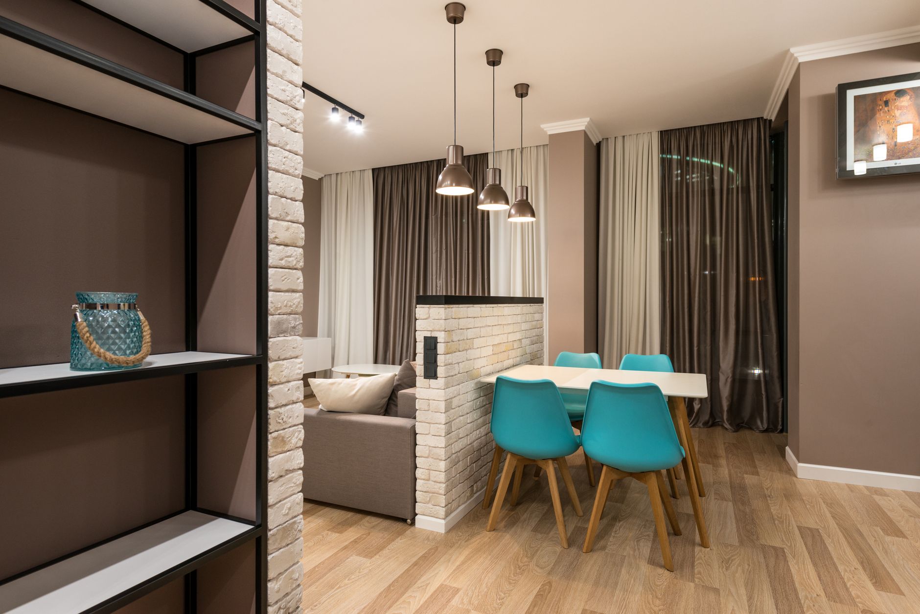 Sofa floating away from wall as natural room divider in open plan apartment