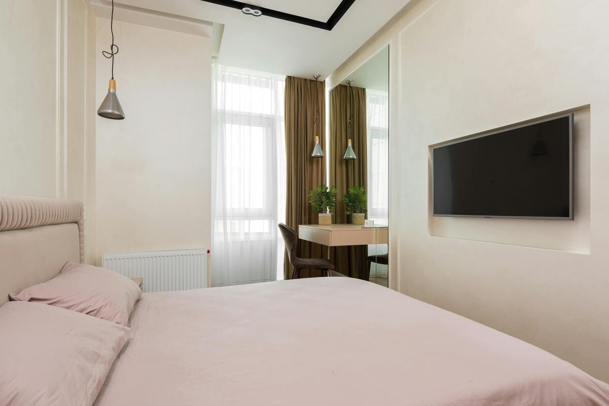 tiny bedroom using vertical storage and a light rug to look bigger